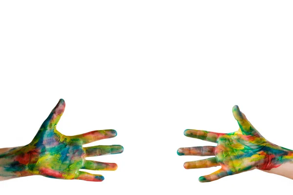 Echando una mano. Primer plano de las manos humanas pintadas en colores brillantes tratando de llegar unos a otros aislados en blanco. Recorte de ruta incluido Imagen De Stock