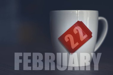 february 22nd. Day 22 of month, Tea Cup with date on label from tea bag. winter month, day of the year concept. clipart