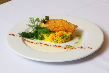 Coocked Pirinç havuç, bezelye, domates, zerdeçal. Yanında bir demet maydanoz ve dereotu duyar ve pirzola. Sos, mayonez ve acı.