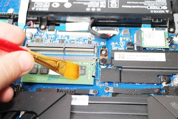 Computer repair: master repairs laptop