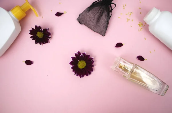 Cosmetics on the table at the woman. Cosmetic bag, cosmetic and hygiene products. Pink background for text