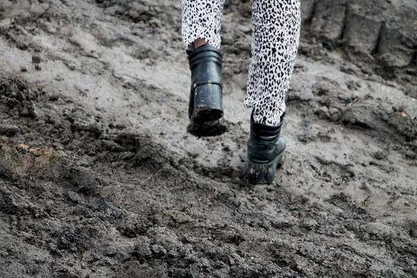 Shoes in the mud. Photo in motion. The concept of provincialism