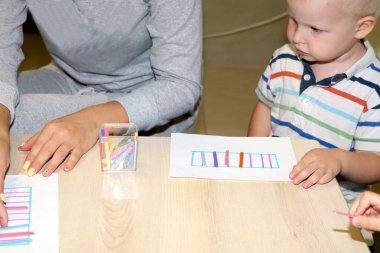 Eğitimci anaokulunda çocuk ile ilgilidir. Yaratıcılık ve çocuk gelişimi