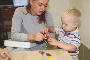 Eğitimci anaokulunda çocuk ile ilgilidir. Yaratıcılık ve çocuk gelişimi