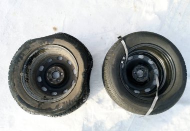 Delikli ve düz lastik yolda. Tekerlek bir jack ile sürücü tarafından yerine