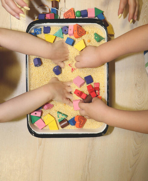 Children playing with kinetic sand, croup and designer in preschool. The development of fine motor concept. Creativity Game concept.