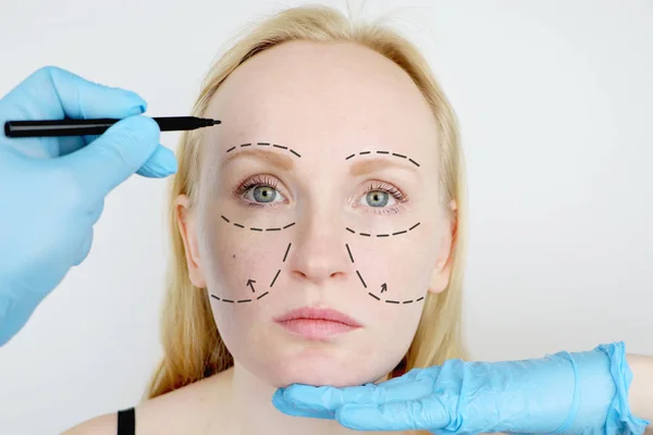 Facial plastic surgery or facelift, facelift, face correction. A plastic surgeon examines a patient before plastic surgery.