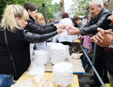 NIKOPOL, UKRAINE - MAY, 2019: distribution of food to the needy, charity event clipart