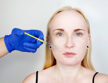 Doktor güzellik kontur plastik dudaklar yürütmektedir: dudaklara bir enjeksiyon, dudak büyütme. Hyaluronik asit enjeksiyon dolgu maddeleri