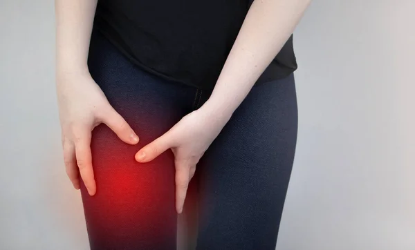 A woman suffers from hip pain. The concept of treating a hip joint for trauma, plantation or osteoarthritis.