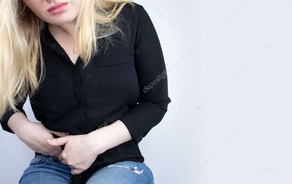 A woman suffers from pain in the appendix. Acute appendicitis, Crohn's disease, or inflammatory bowel disease. Surgeon examination and preparation for laparoscopic appendectomy