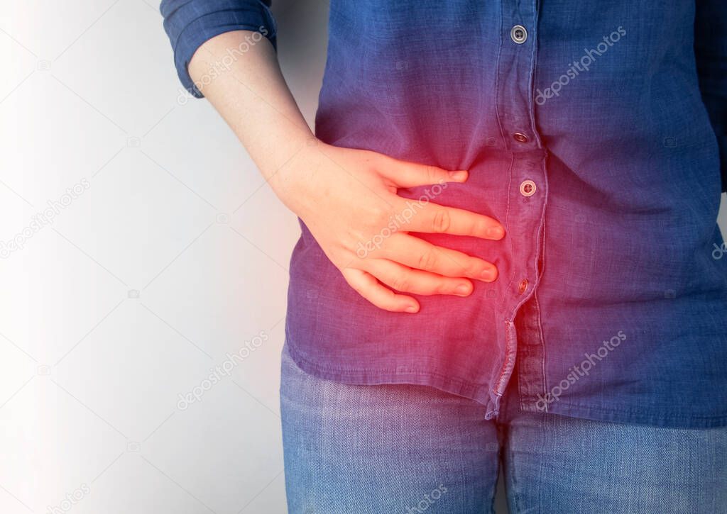 A woman suffers from pain in the appendix. Acute appendicitis, Crohn's disease, or inflammatory bowel disease. Surgeon examination and preparation for laparoscopic appendectomy