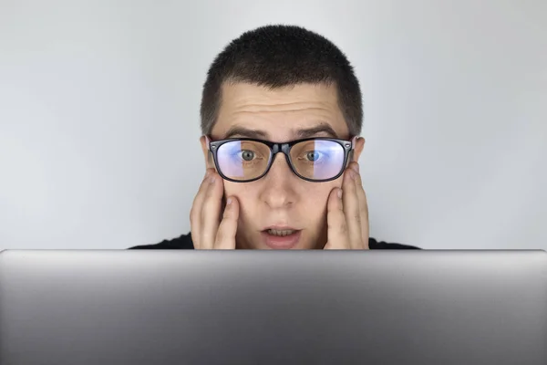 Man Looks Laptop Frightened What Saw Expressing Emotions Reacting What Stock Photo