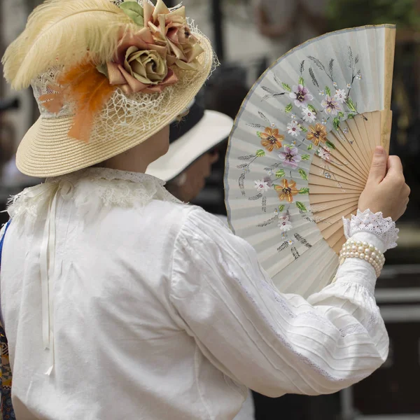 Woman using a fan