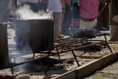 Domuz omzu açık havada bir tavada kaynıyor