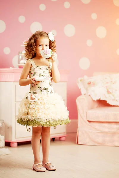 Little Cute Girl Pink Dress Drinks Tea Sweets Children Room — Zdjęcie stockowe