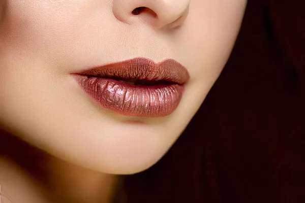 Red woman lips close up. Beautiful model girl with lipstick, manicure with nail polish Products Treatment