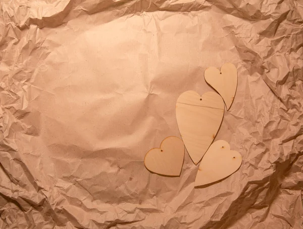 Wooden Hearts Crumpled Kraft Paper — Stock Photo, Image