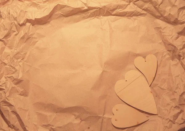 Wooden Hearts Crumpled Kraft Paper — Stock Photo, Image