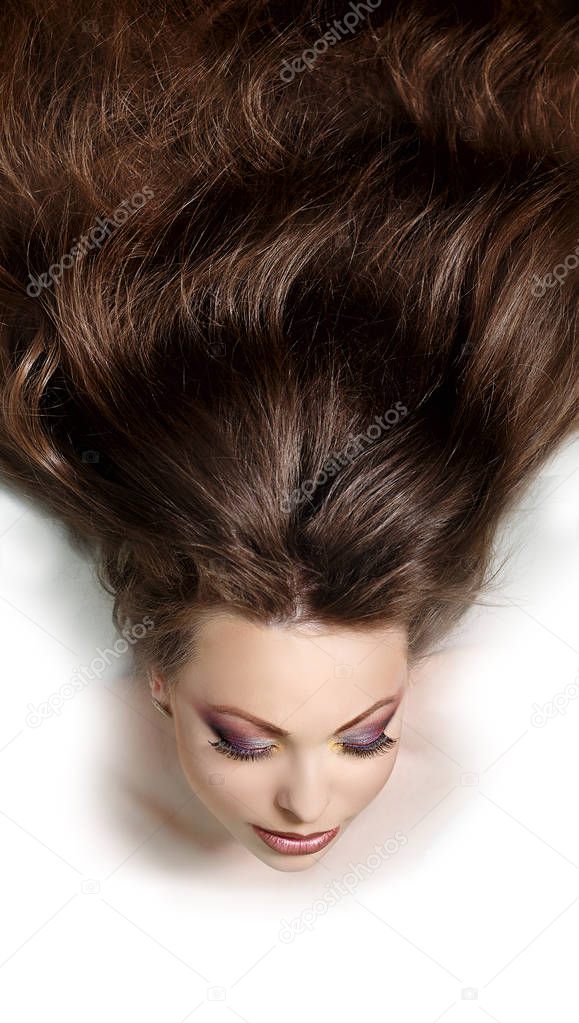 Beauty portrait of a beautiful young girl with luxurious hair, fresh skin. Voluminous curly hair wave.