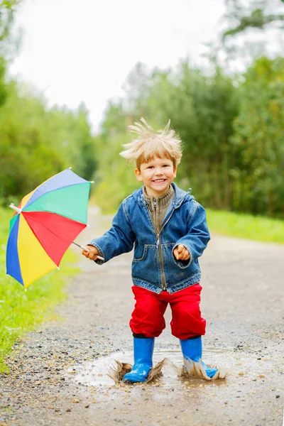 Child Jumps Puddles Boots Baby Rain Boy Rainbow Umbrella Walking — Stock Photo, Image