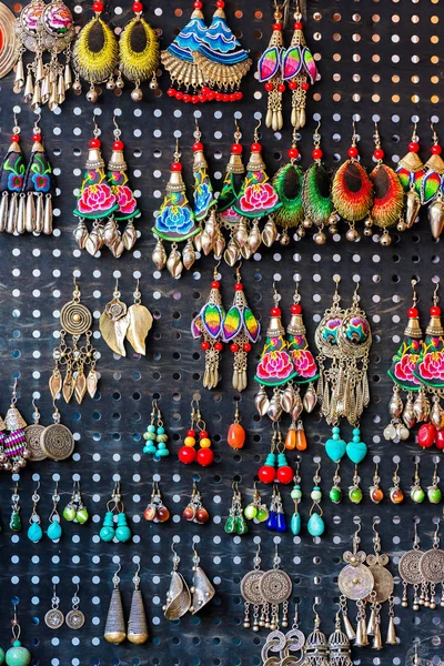 Colorful decoration for sale. Earrings handmade, Luang Prabang, Laos. Close-up. Vertical