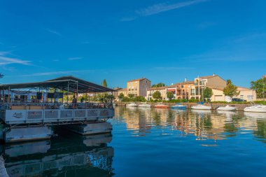 AGDE, FRANCE, JULY 19th 2020: Restaurant on the Herault river at the port of Agde, Languedoc-Roussillon France clipart