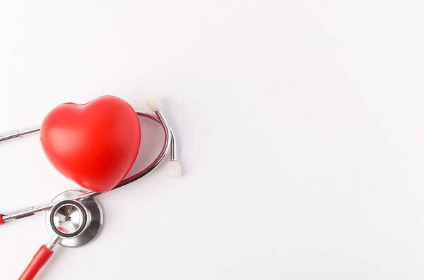 Red heart with stethoscope on white background. Selective focus.