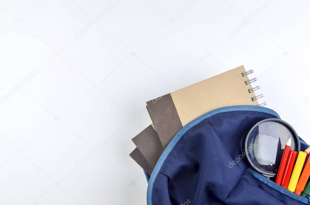 View of flat lay with school backpack and stationery with space for text on white background. Selective focus.