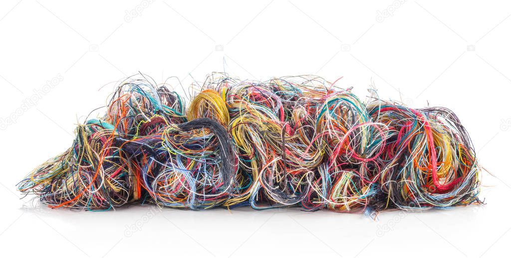 Colorful tangled threads isolated on white background. Closeup.