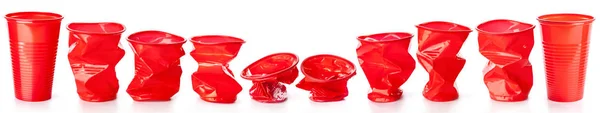 Rode verfrommeld plastic bekers geïsoleerd op witte achtergrond — Stockfoto