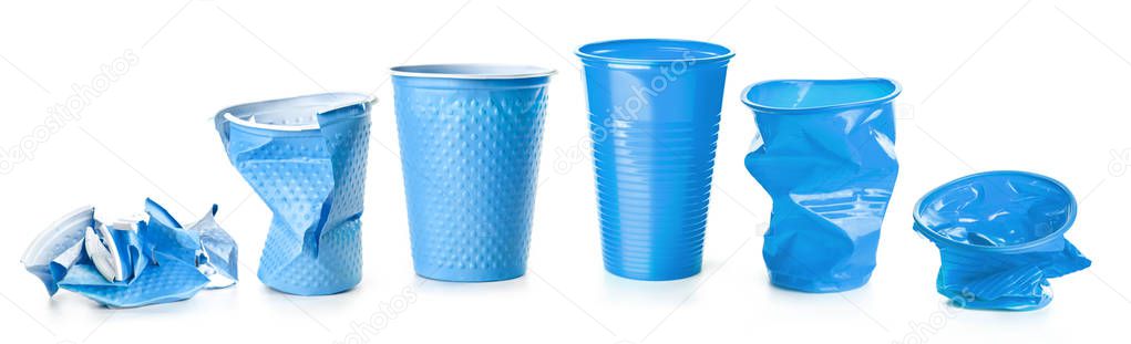 Blue crumpled plastic cups isolated on white background