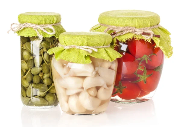 Capers, tomatoes and garlic preserved in glass jar isolated on w — Stock Photo, Image