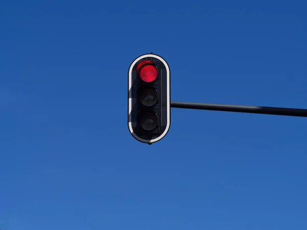 Red traffic sign is front of the blue sky isolated