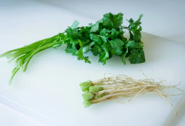 coriander root with leaf vegetable on the cutting board