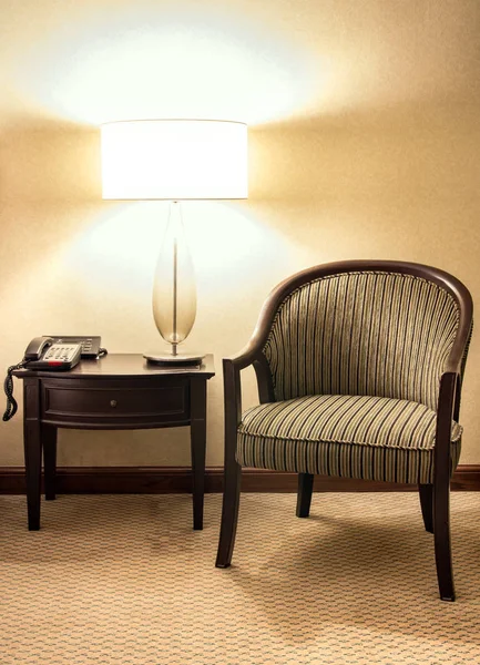 Table lamp with wooden chair in the bedroom at night time