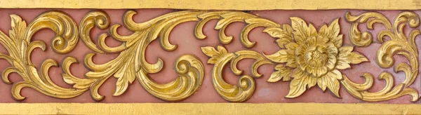 Pattern of gold flower carved on stucco design of native wall, T — Stock Photo, Image