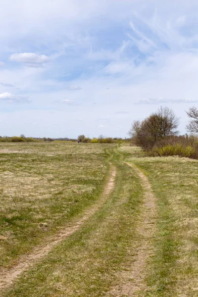 Rural landscape in spring, clouds floating in the blue sky