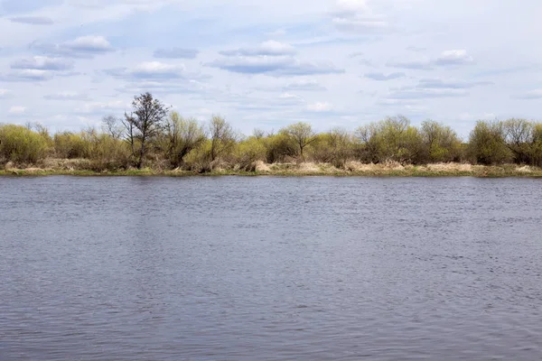 Nehir ve bulutlar durgun gökyüzünde süzülüyor