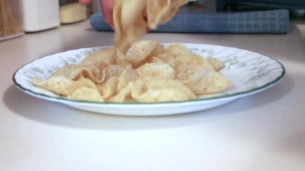 Hand Drops Some Crunchy Nacho Tortilla Chips Plate — Stock Video