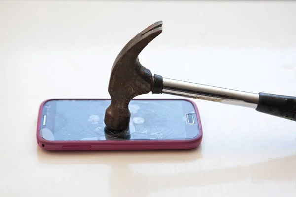 拿起锤子砸碎手机 — 图库照片