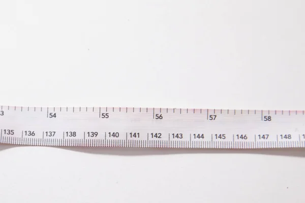 White measuring tape against a white background — Stock Photo, Image