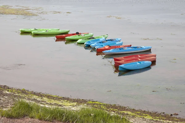 Green, red and blue kayaks