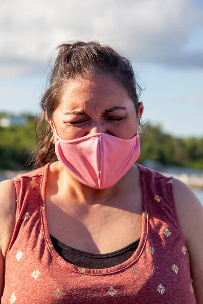 woman crying or yelling into her face mask in frustration