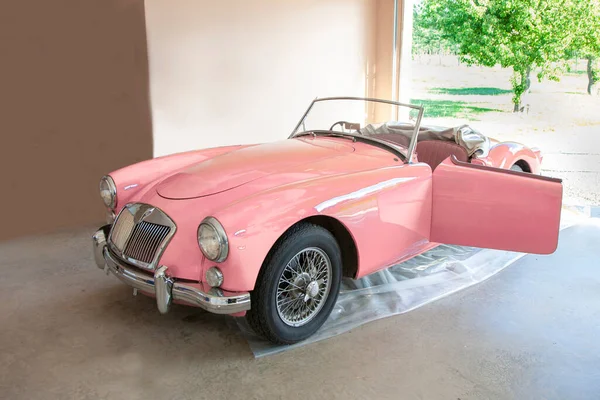 beautiful top down pink car in the shed well loved and ready to ride