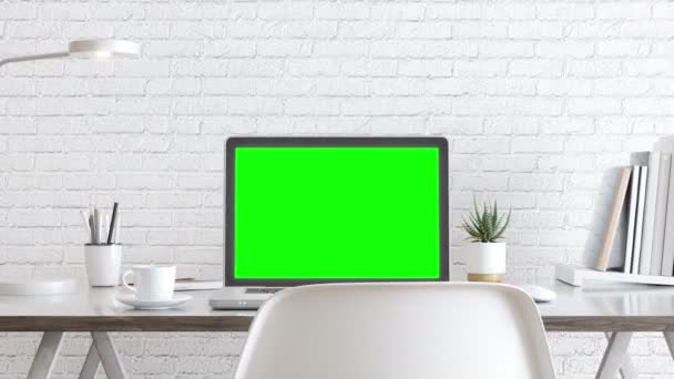 白い画面のノートパソコンと緑の画面の机の上のオフィス用品 — ストック動画