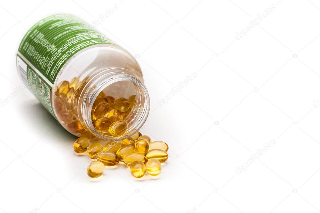 Omega 3 fish oil capsules spilled from a plastic bottle on a white background. Medical food supplements. Unsaturated fatty acid. Health care concept.