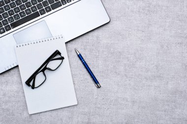 Ofis aksesuarları ile üst görünüm Office masaüstü, dizüstü bilgisayar ve gözlük ile Masaüstü ve kalemli not. Tasarımınız veya yüklemeniz için boş alan içerir. İş ve iş kavramı.