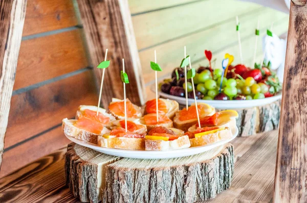 Bir tabakta taze doğranmış somon fileto ve limon ile lezzetli sandviçler. Bir tatil hafta sonu ve piknik kavramı.