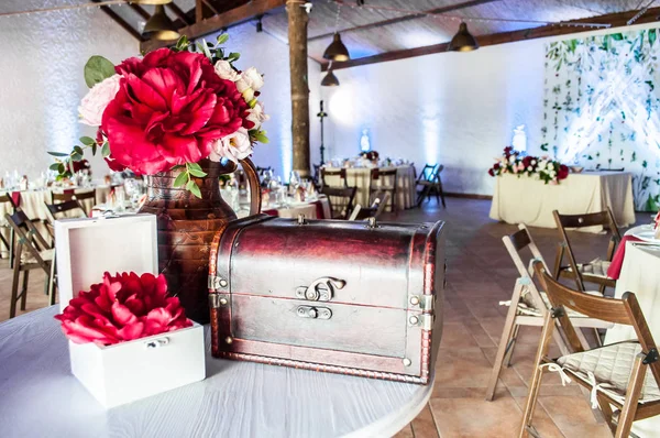Kutlama öncesi dekore edilmiş bir salonun arka planında antika kutu ve güzel bir buket.